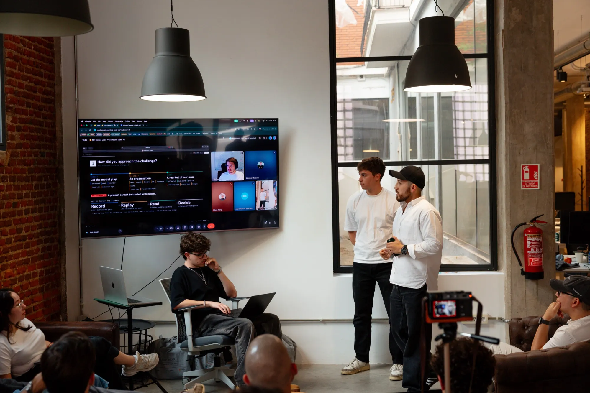 The team giving the pitch next to the screen