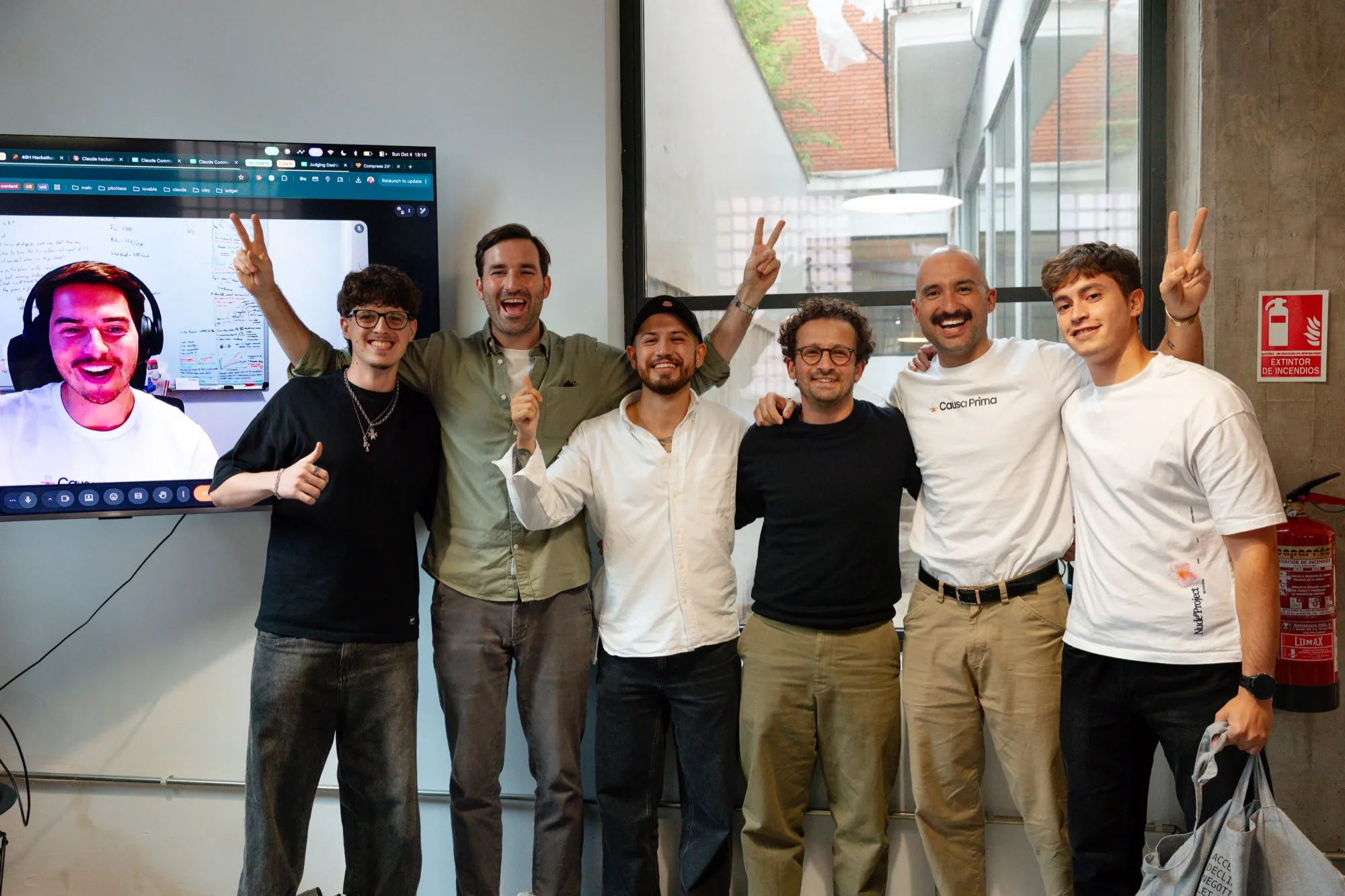 The team celebrating with the organisers after the result